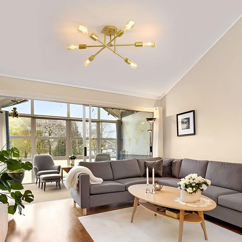 Modern living room with gray sectional sofa, wooden coffee table, and gold ceiling light fixture.