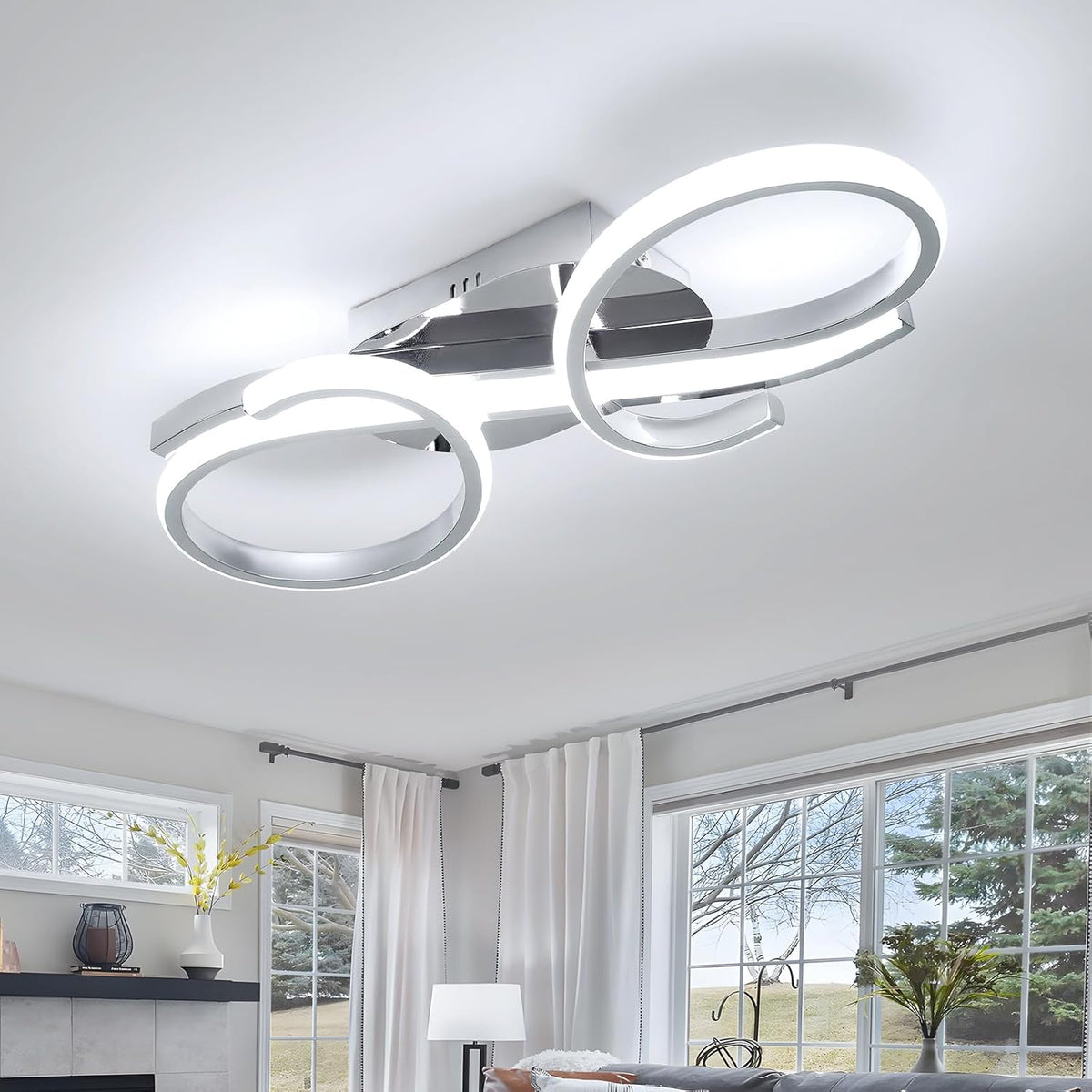 Modern ceiling light fixture in a living room with large windows