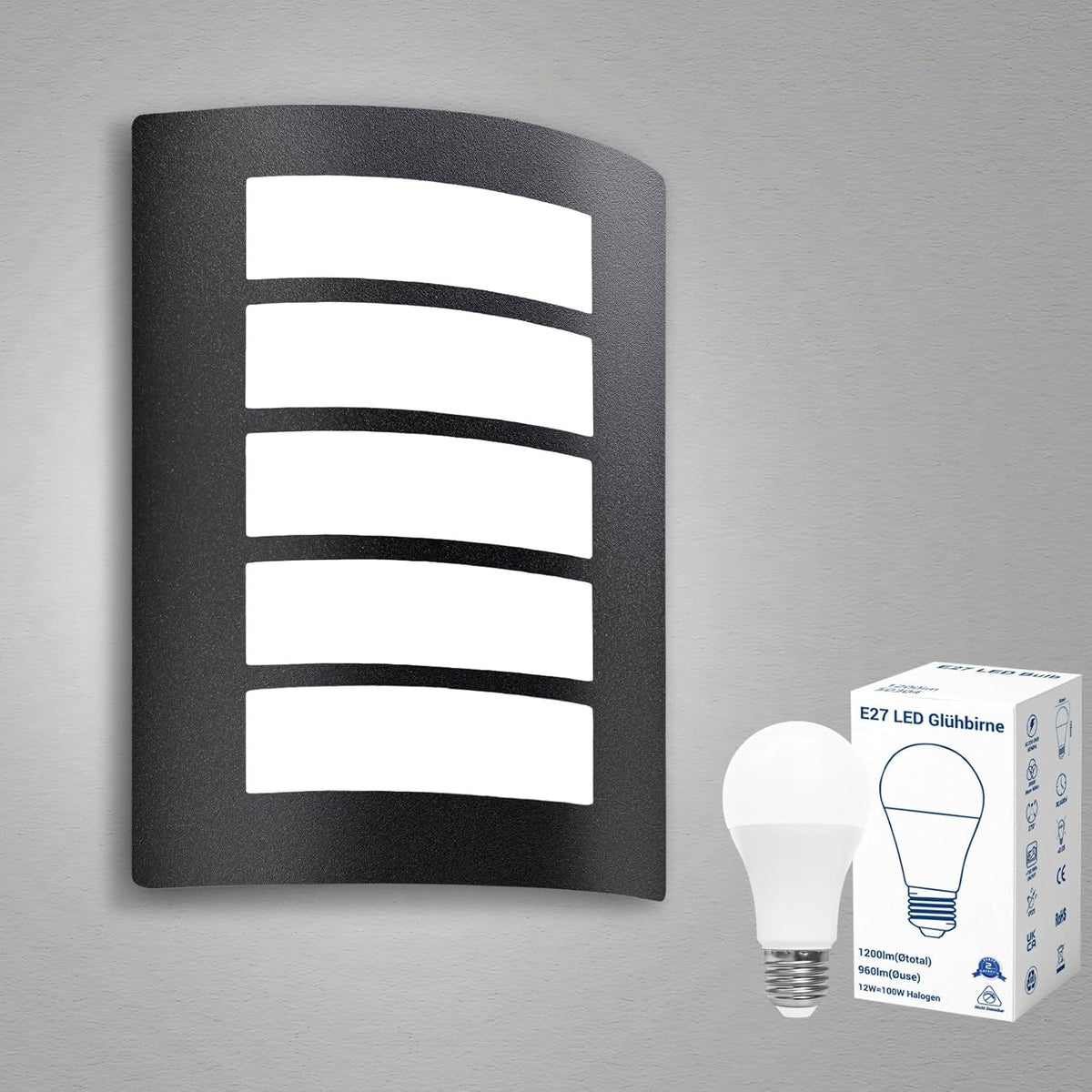 Black outdoor wall light fixture with LED bulb and packaging on a gray background