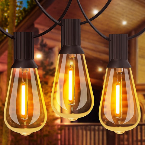 Outdoor 24FT festoon lights with warm white LED bulbs illuminating a garden patio

