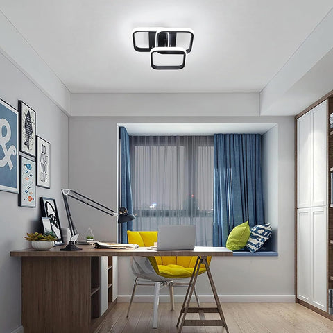 Modern home office with a desk, chair, and window seat.