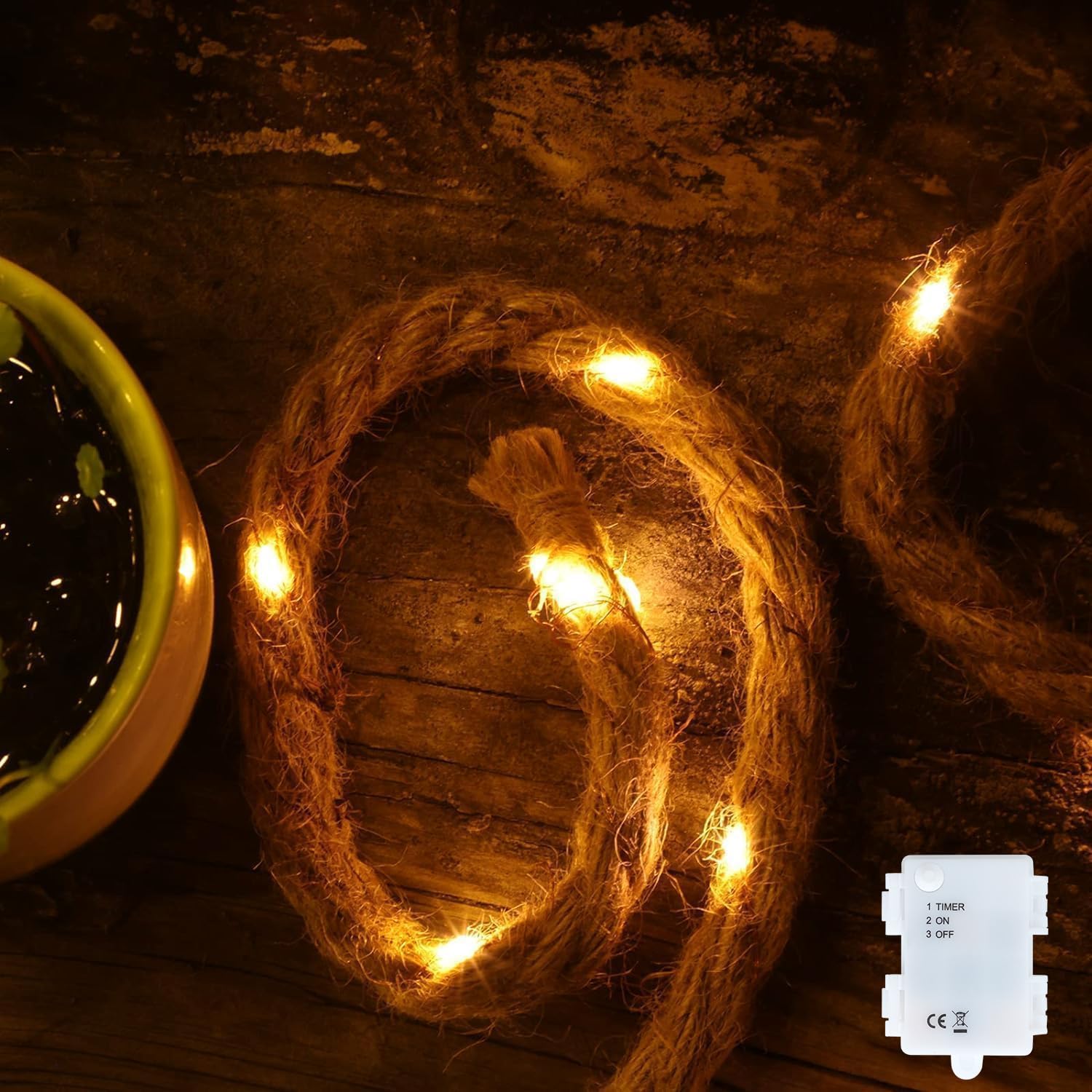 Coiled rope with embedded lights on a rustic wooden surface