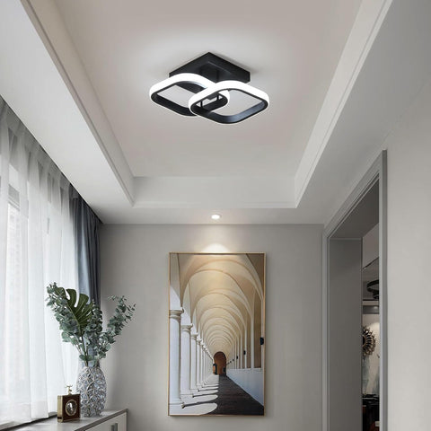 Modern ceiling light fixture in a stylish hallway with a painting on the wall.