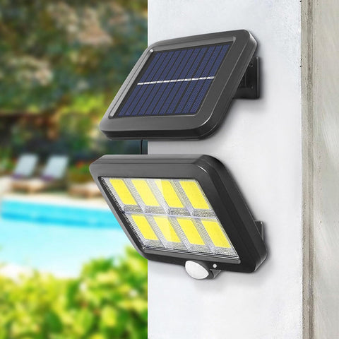Solar-powered garden light lighting up a driveway at night with automatic motion activation


