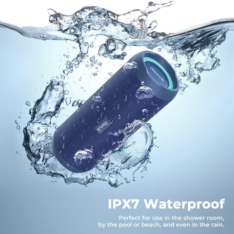 Rexroth waterproof Bluetooth speaker with water splashes around it on a light blue background.