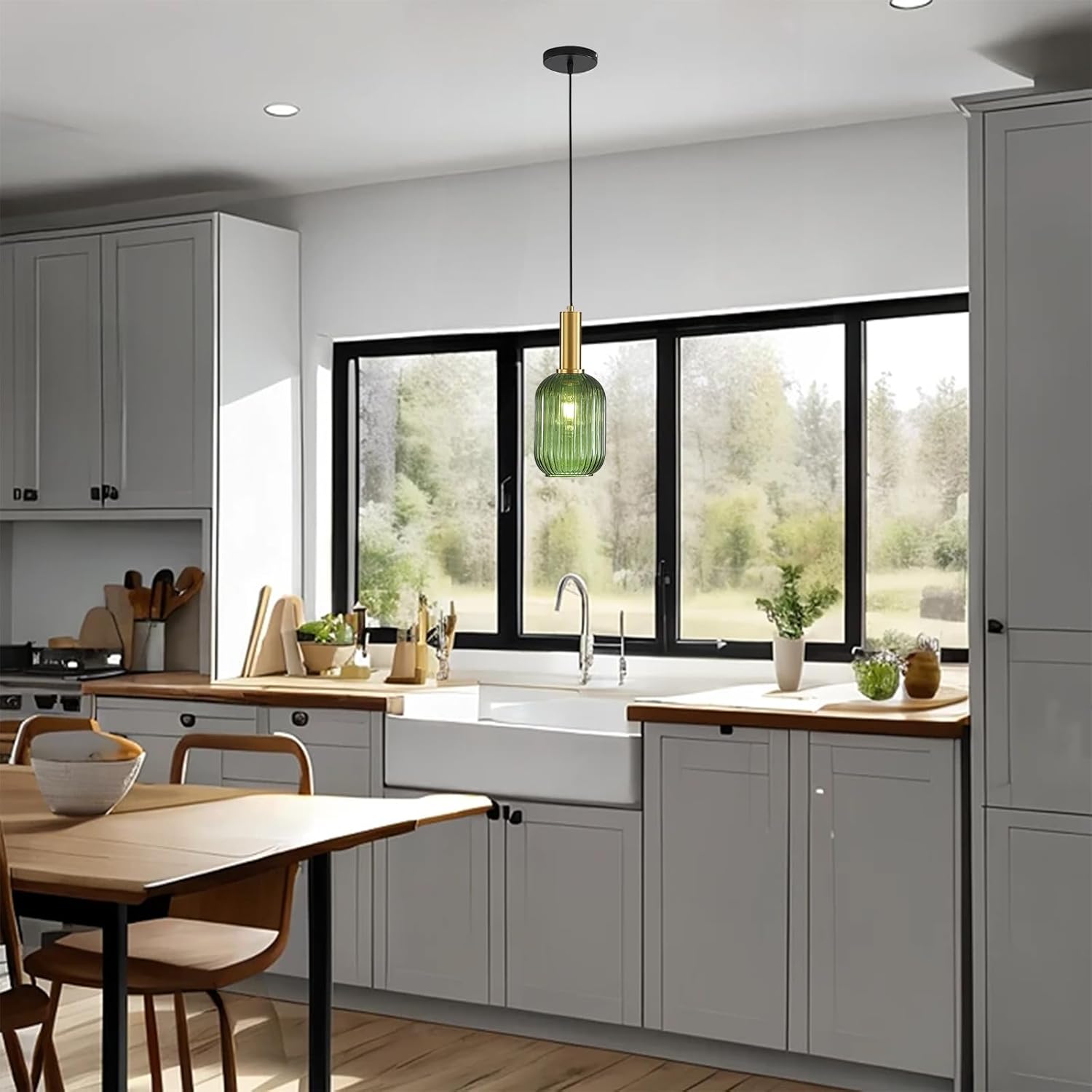 Modern kitchen with gray cabinets, wooden countertops, and a green pendant light.
