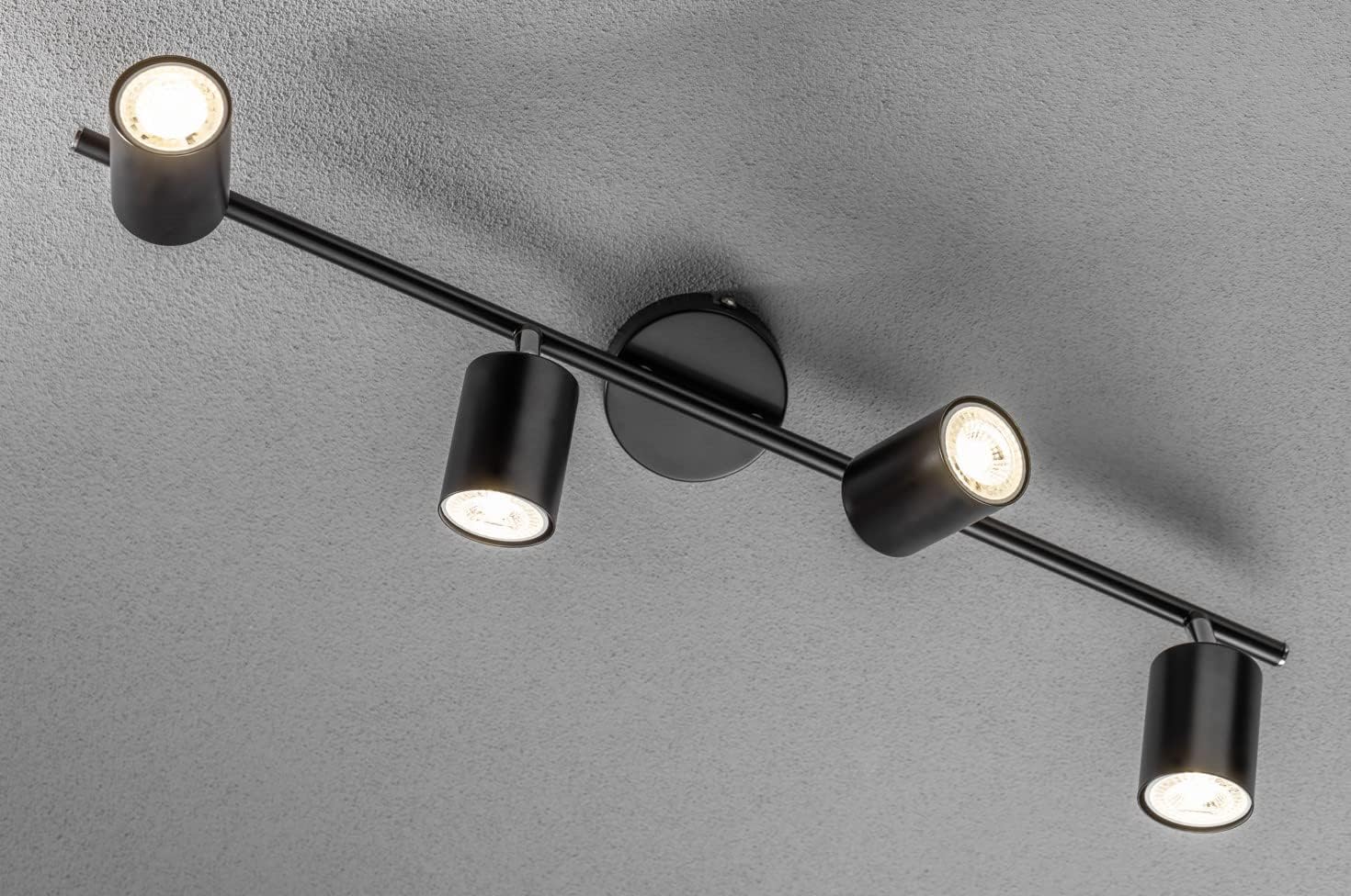 Black ceiling light fixture with four lights on a gray background