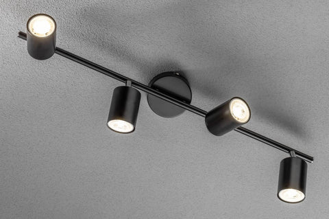 Black ceiling light fixture with four lights on a gray background