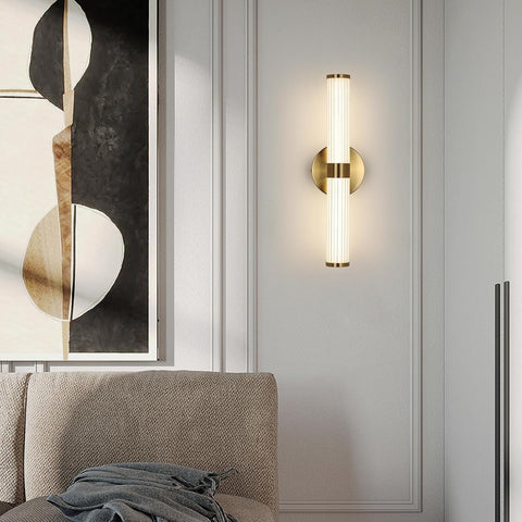 Wall-mounted lamp on a gray wall with abstract art in the background