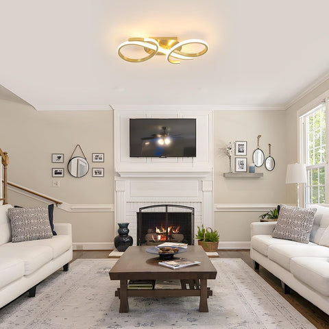 Living room with white sofas, a wooden coffee table, and a fireplace.