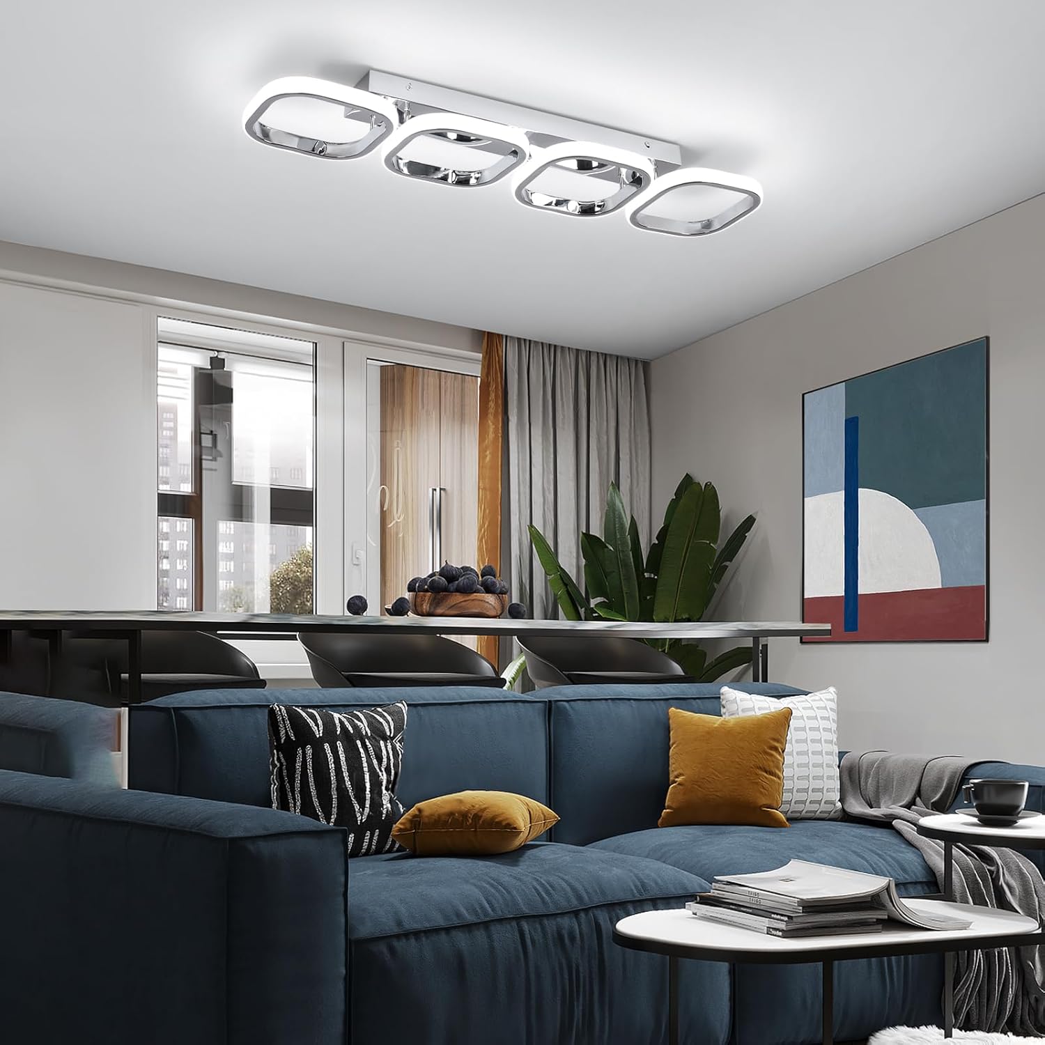 Modern living room with a blue sofa, decorative pillows, and a ceiling light fixture.