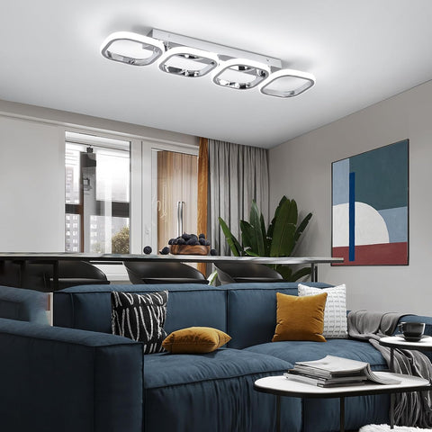 Modern living room with a blue sofa, decorative pillows, and a ceiling light fixture.