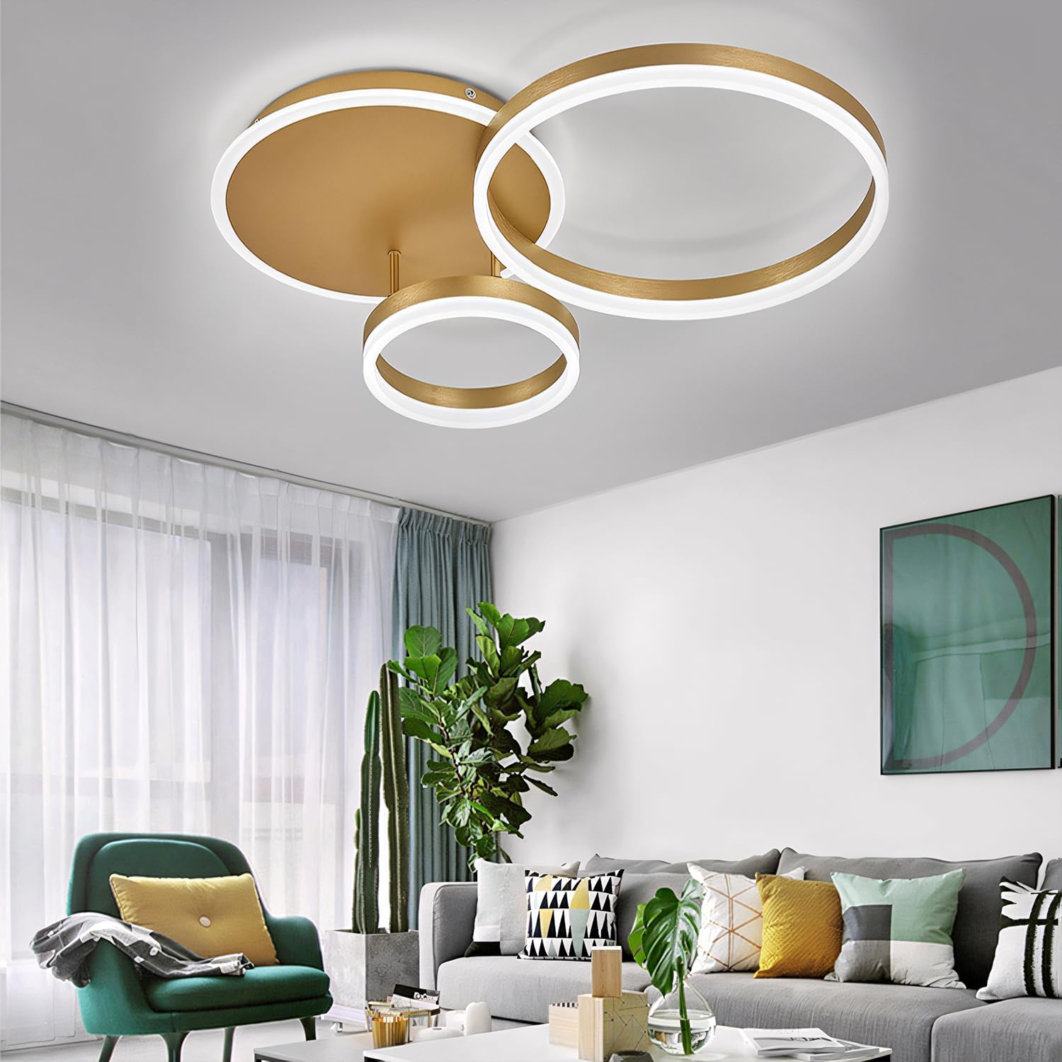 Modern living room with a gold ceiling light fixture, green armchair, and gray sofa.