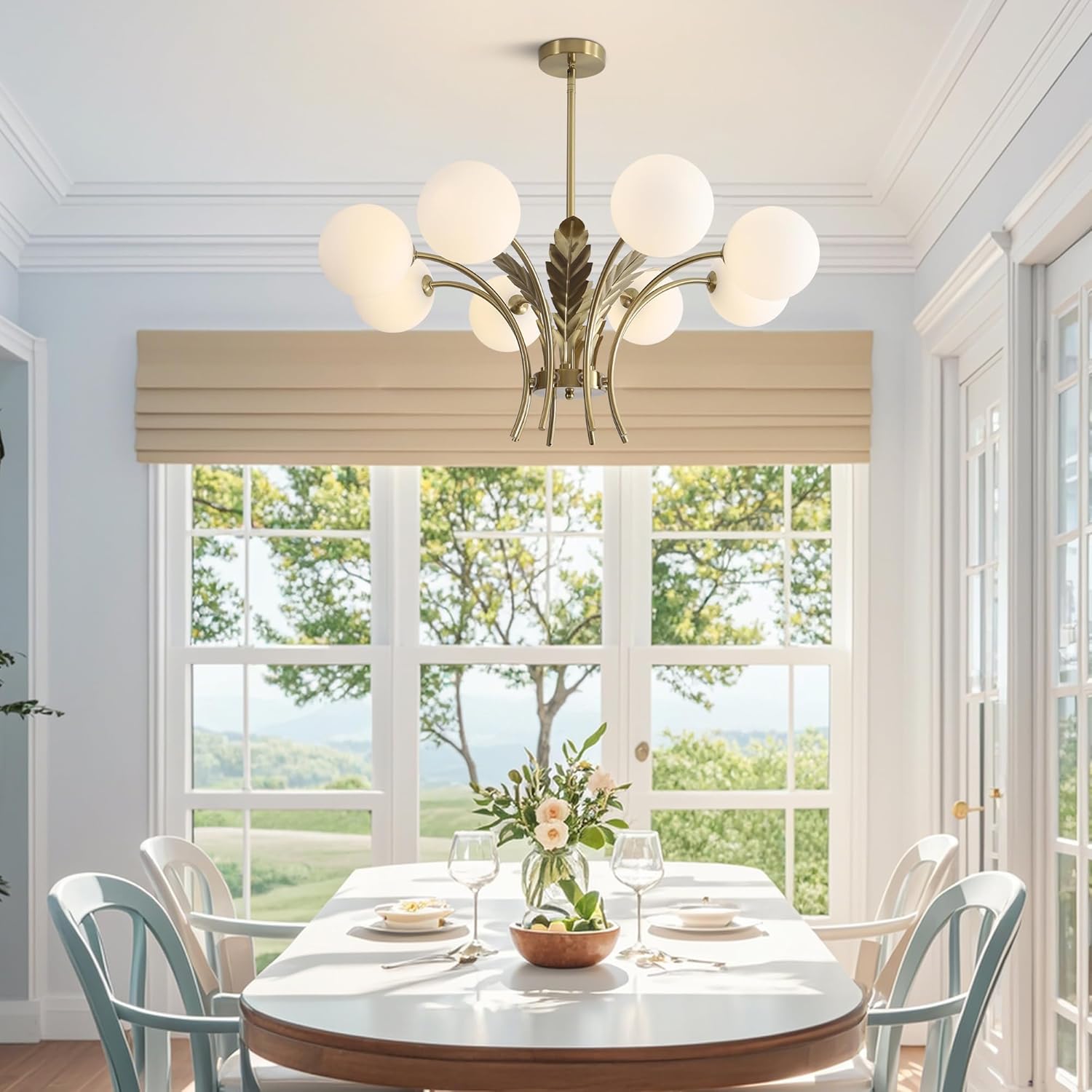 Dining room with a chandelier, table, chairs, and a view of trees outside.
