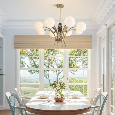 Dining room with a chandelier, table, chairs, and a view of trees outside.