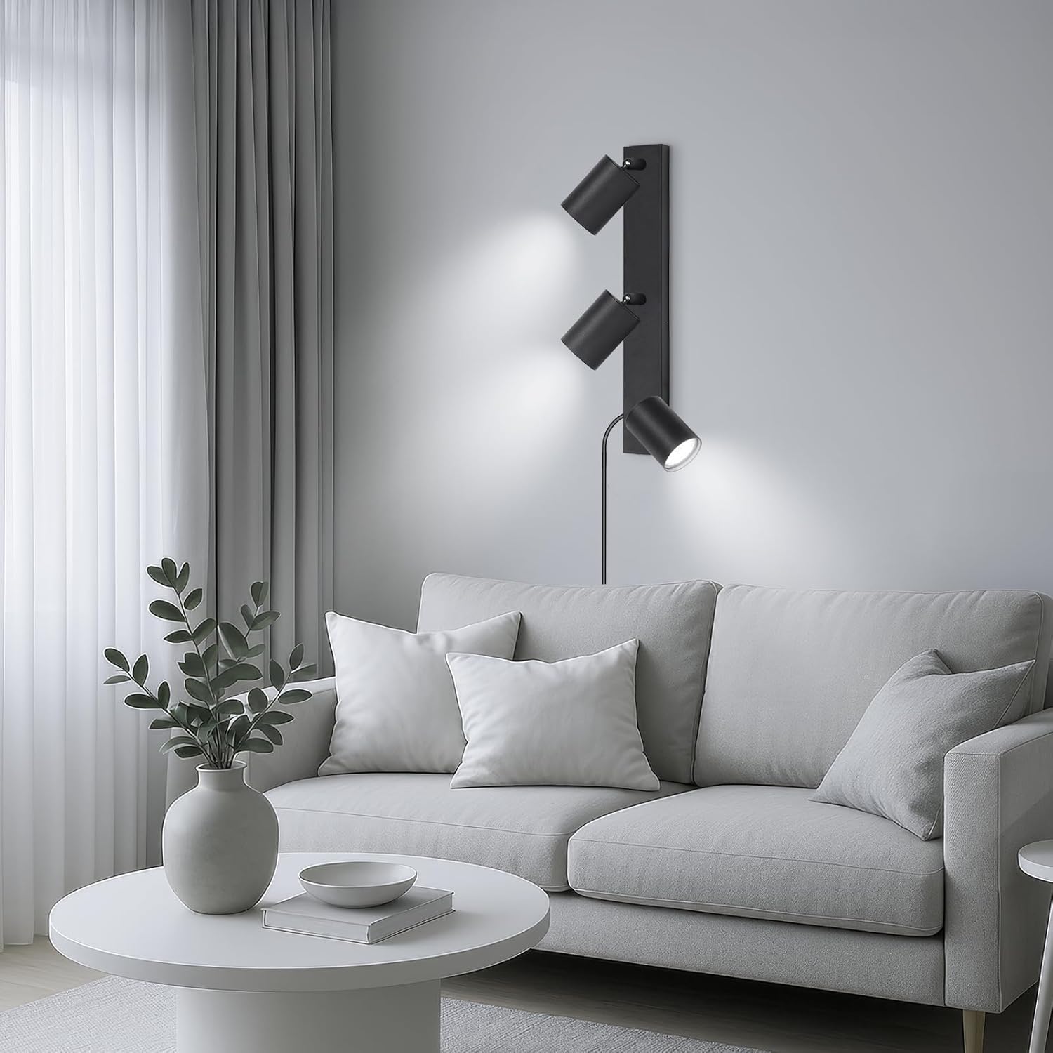Modern living room with a gray sofa, white coffee table, and wall-mounted lamp.