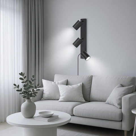 Modern living room with a gray sofa, white coffee table, and wall-mounted lamp.