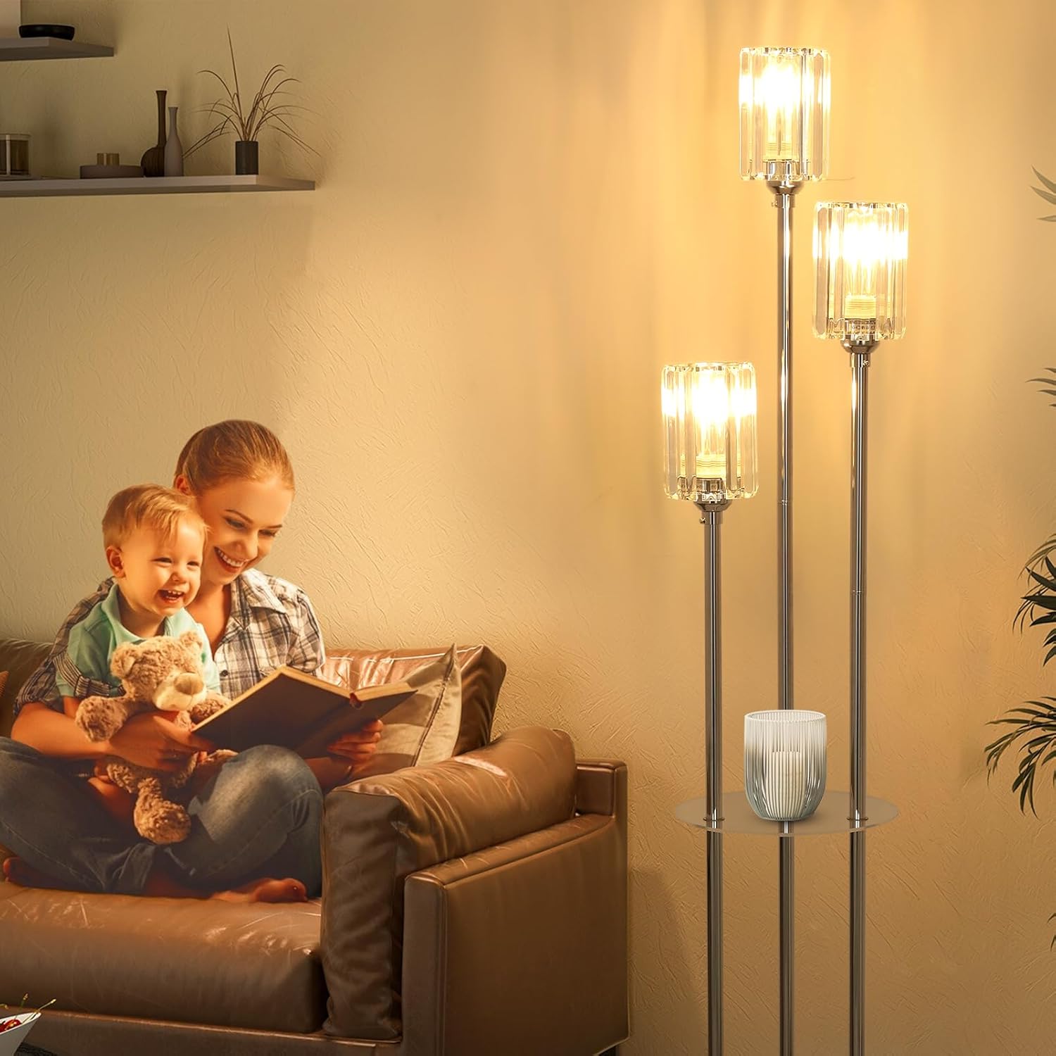 Woman and child reading a book on a couch with floor lamps in the background