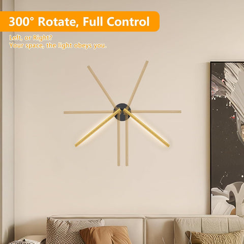 Modern wall light fixture with wooden arms on a neutral wall above a sofa.