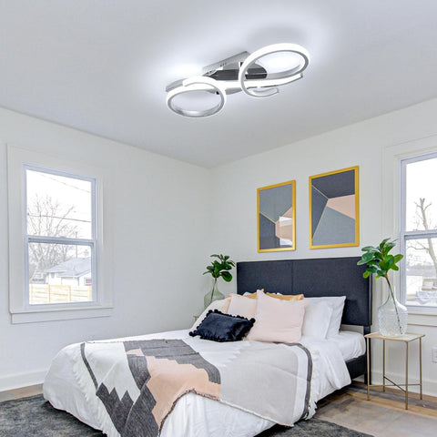 Modern bedroom with a bed, nightstands, and wall art.