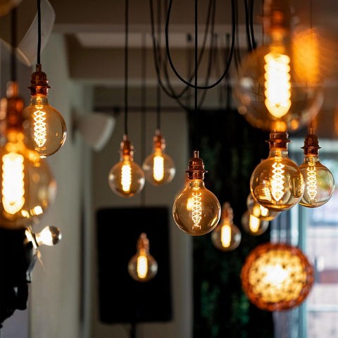 Vintage-style light bulbs hanging in a room with a blurred background