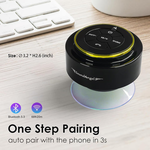 Black Bluetooth speaker with SoundAngel branding on a desk with keyboard and mug