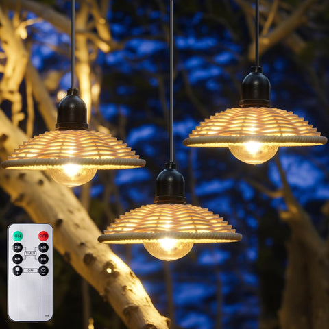 Three hanging light bulbs with woven shades against a blurred natural background