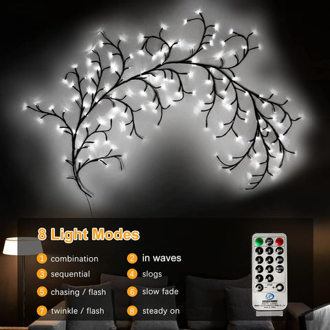 Decorative light fixture with branches and remote control on a dark background