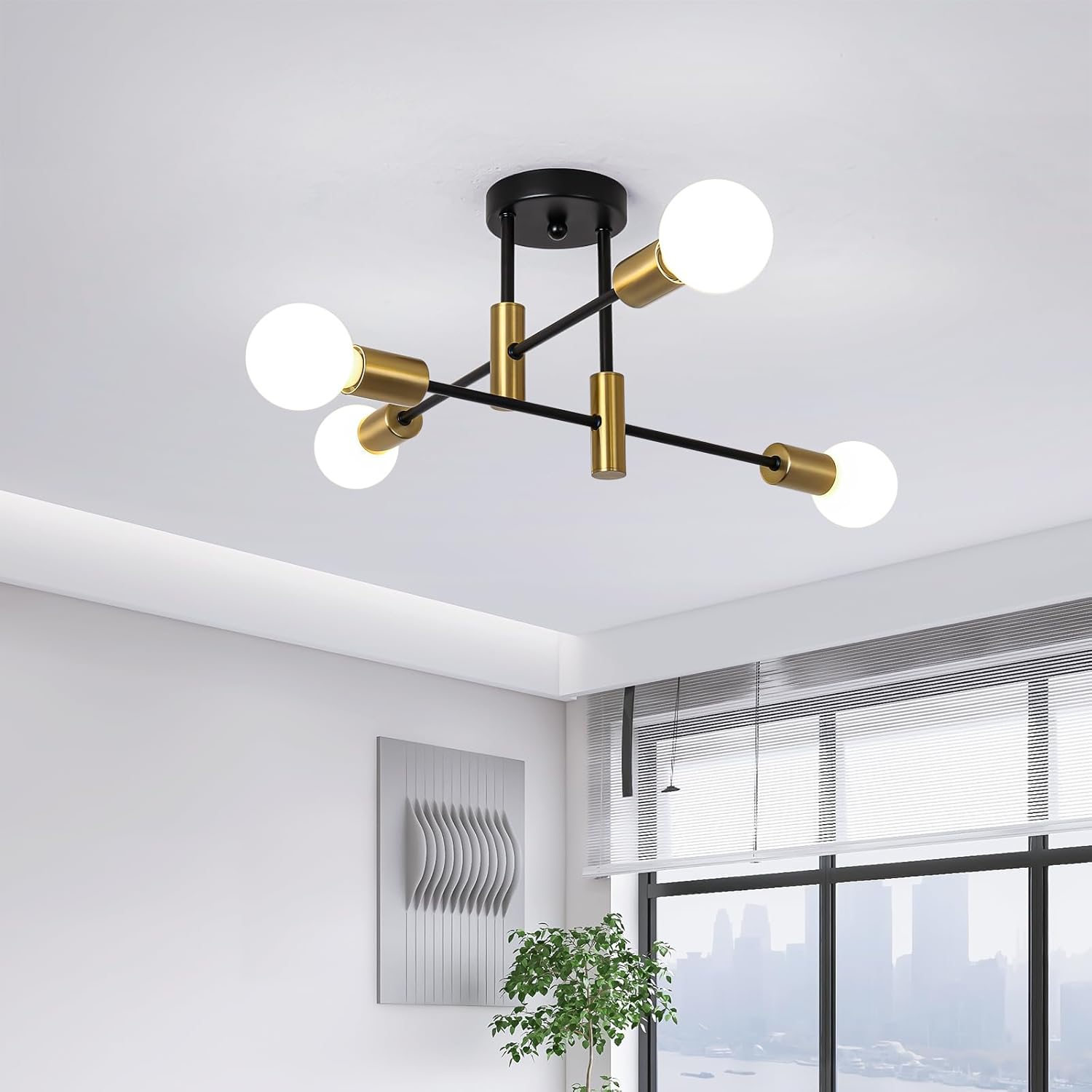 Modern ceiling light fixture with gold and black design in a room with large windows.