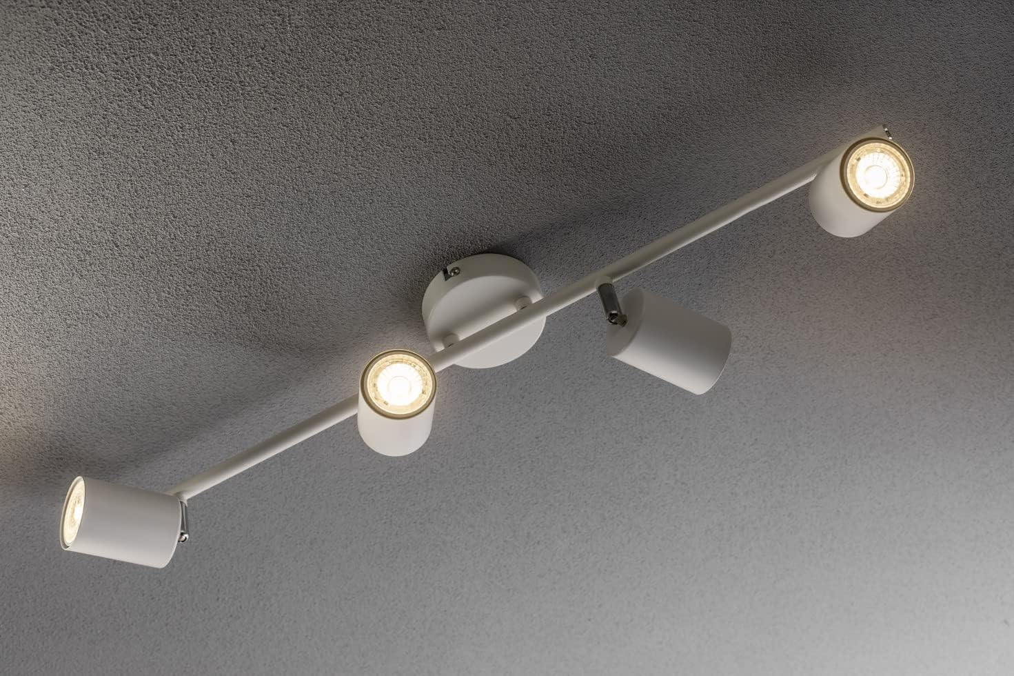 Ceiling-mounted light fixture with four lights on a gray ceiling