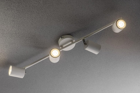 Ceiling-mounted light fixture with four lights on a gray ceiling