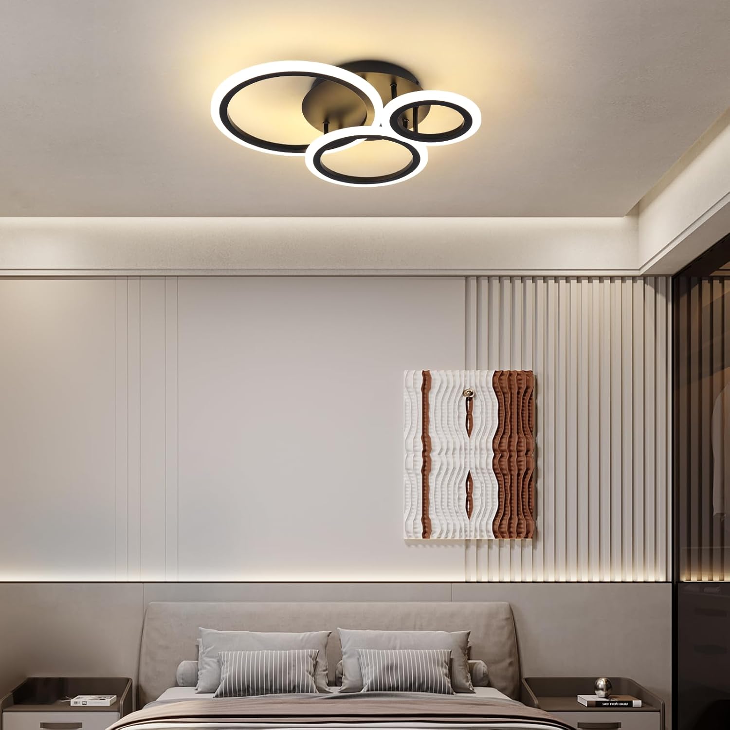 Modern bedroom with a ceiling light fixture and abstract wall art.