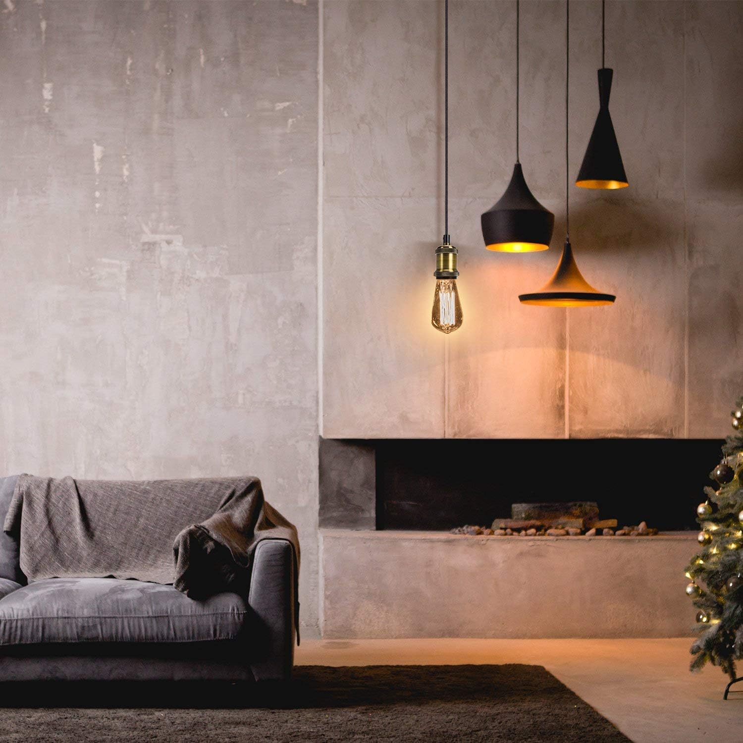 Modern living room with gray sofa, concrete wall, and hanging pendant lights.