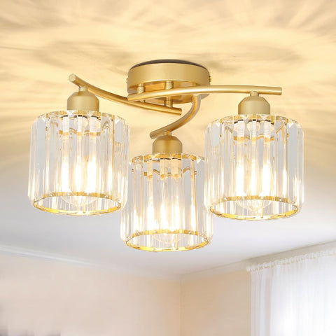 Ceiling light fixture with gold finish and clear glass shades in a room setting.