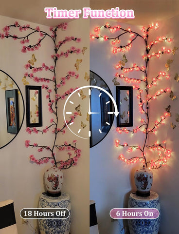 Decorative branch with pink lights on a white wall, showing timer function.