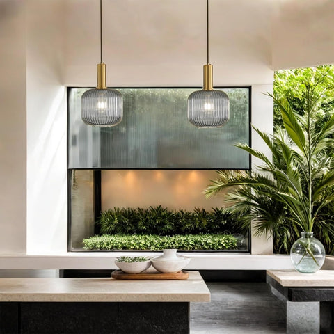 Modern interior with a television, decorative plants, and pendant lights.
