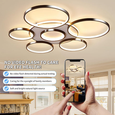 Modern ceiling light fixture with smartphone showing a living room scene, emphasizing eye health benefits.