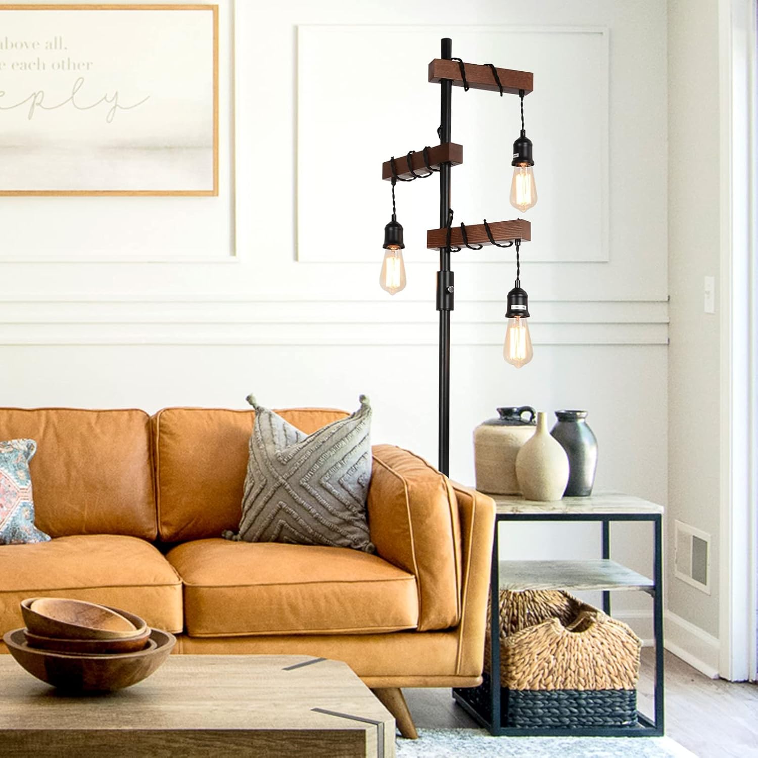 Living room with a brown leather sofa, decorative pillows, and a floor lamp.
