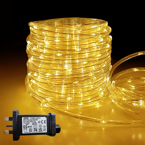 Coiled string lights with a power supply on a dark background