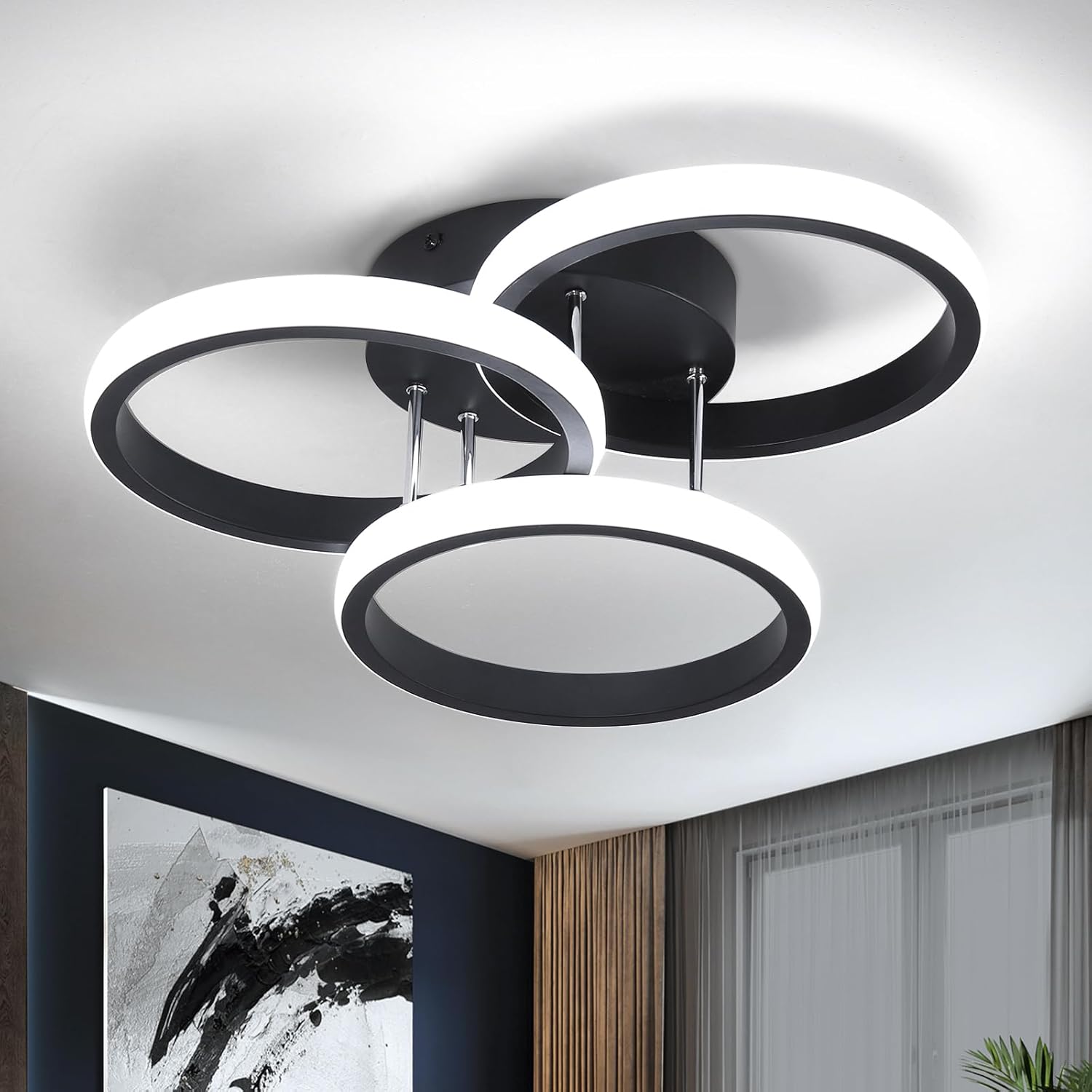 Modern ceiling light fixture with circular design in a room setting.