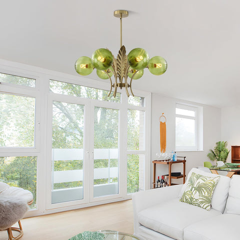 Living room with a modern chandelier, white sofa, and large windows.
