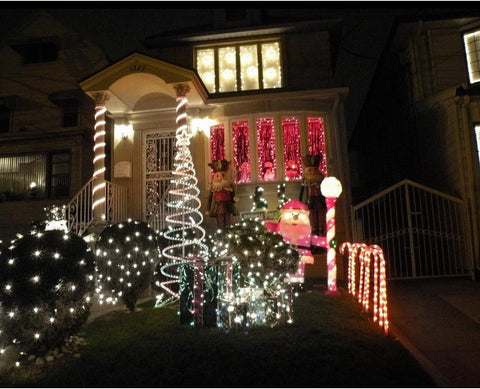 House decorated with Christmas lights and ornaments at night
