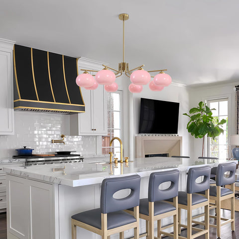 Modern kitchen with pink pendant lights, gray bar stools, and a television mounted on the wall.