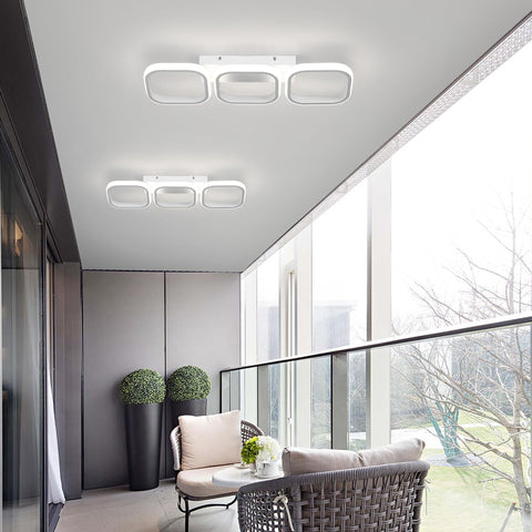 Modern indoor setting with ceiling lights and a view of trees outside.