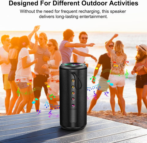 Black portable speaker on a wooden surface with people dancing in the background at a beach.