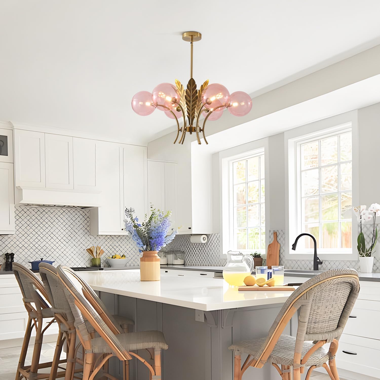 Modern kitchen with white cabinets, a chandelier, and a dining area.