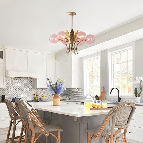 Modern kitchen with white cabinets, a chandelier, and a dining area.