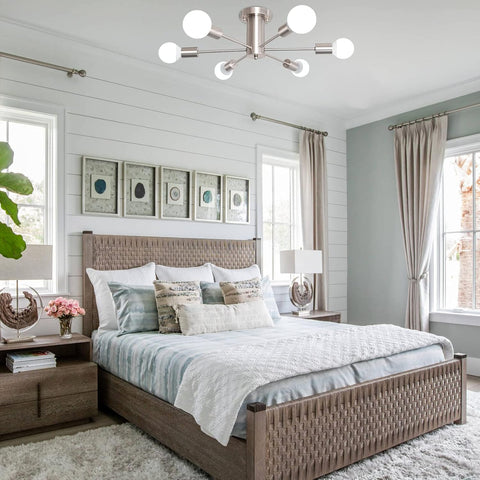 Modern bedroom with a bed, nightstands, and decorative elements.