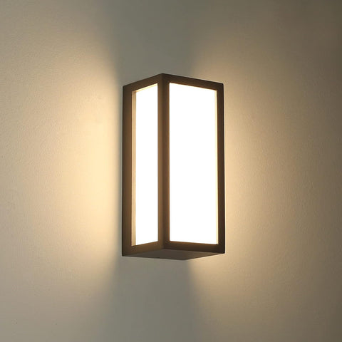 Anthracite grey aluminum outdoor wall light mounted on a brick exterior, providing soft illumination


