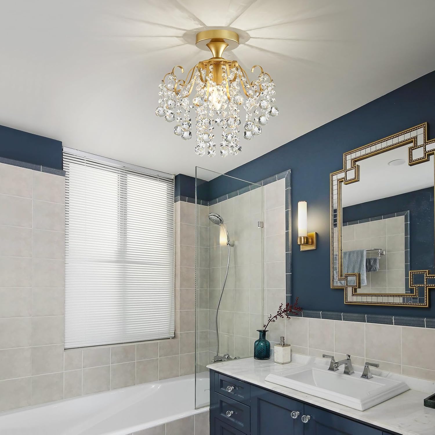 Bathroom with a gold chandelier, blue walls, and a shower area.